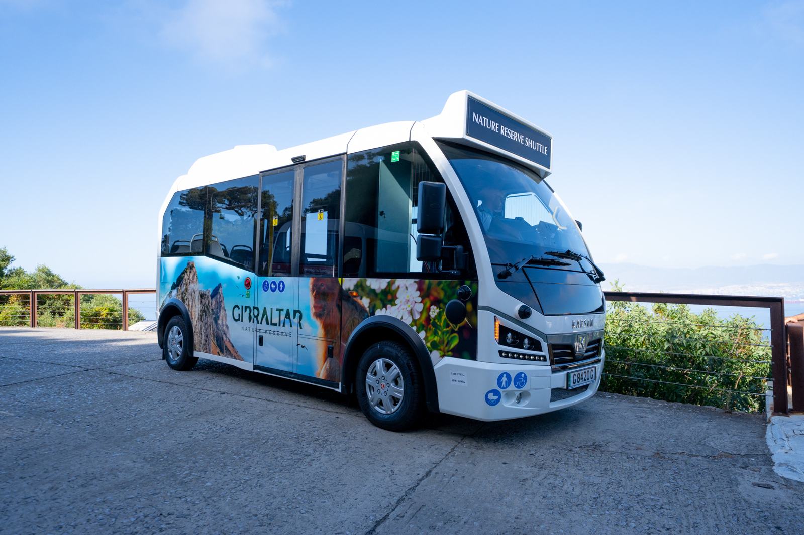 The Nature Reserve Shuttle — a white electric minibus wrapped in Gibraltar Nature Reserve imagery